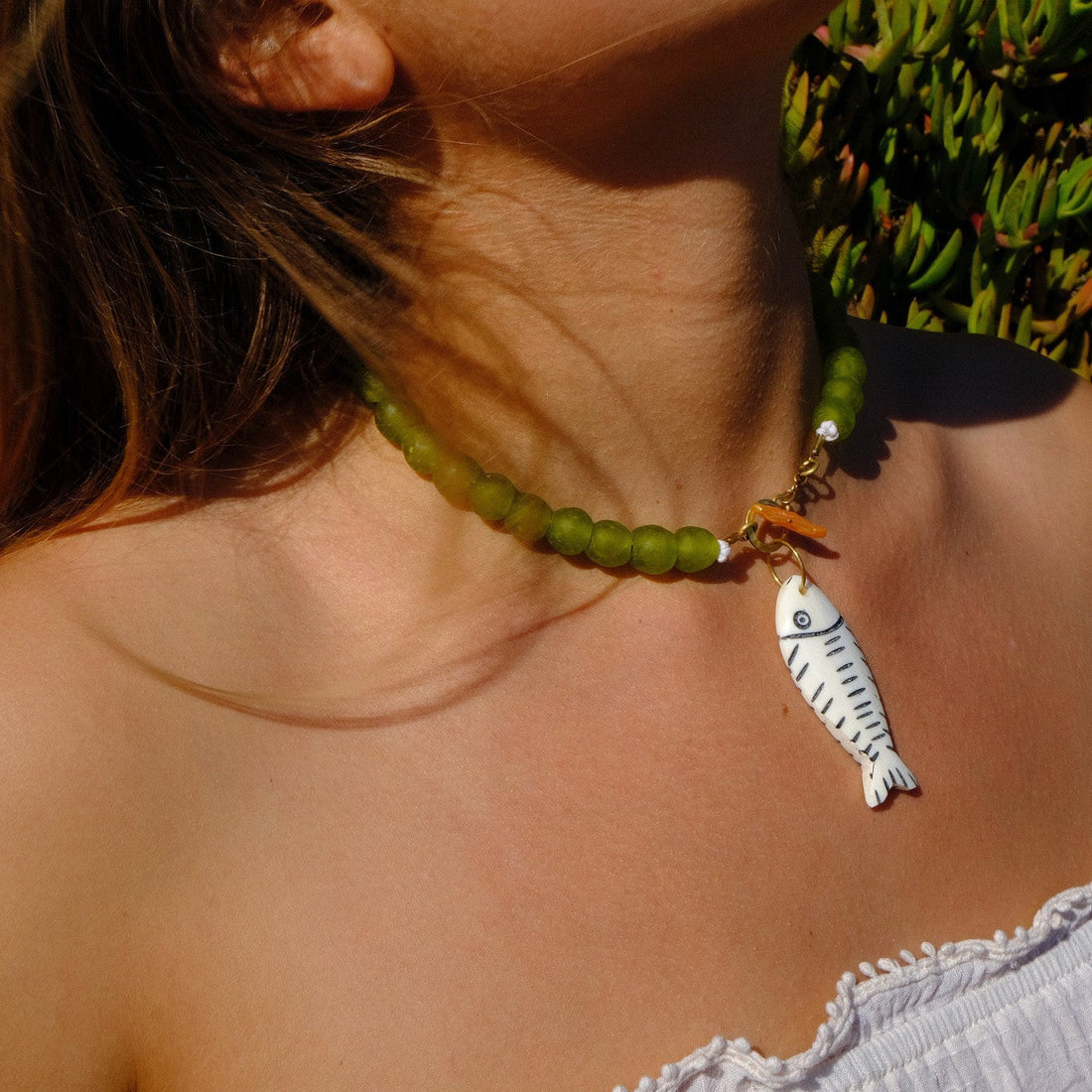 Women Wearing Fish Necklace with Green Beads